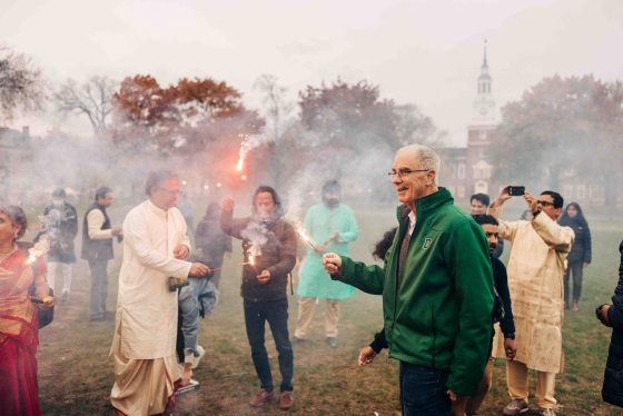 President Hanlon holding a sparkler at the Diwali celebration