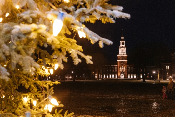 Baker tower framed by lit Christmas tree branches