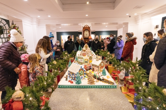 People gathered around Gingerbread display table