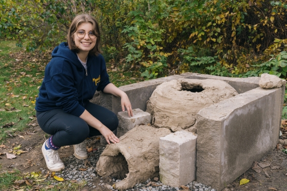 Anne Johnakin '23 and her Bronze Age-style kiln.