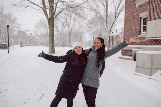 Two people posing in a snowstorm