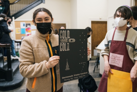 A student holding up a poster that reads &quot;cold so cold&quot;
