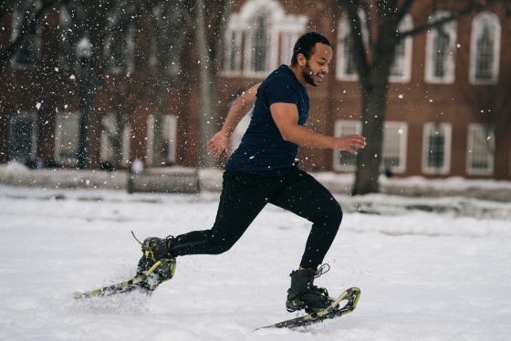 A student running in snowshoes