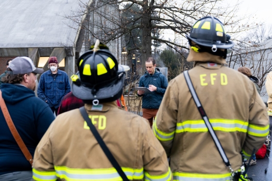 Firefighters and others standing with yellow EFD on their coats