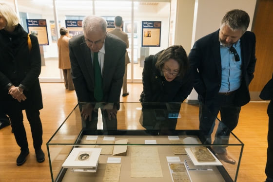 Phil Hanlon and others looking at a display case
