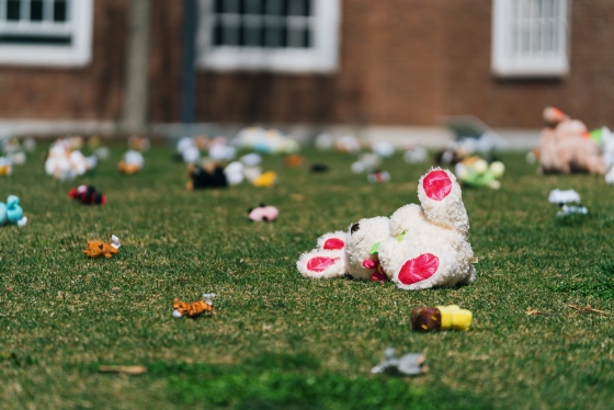 A stuffed bunny and other toys scattered on the ground