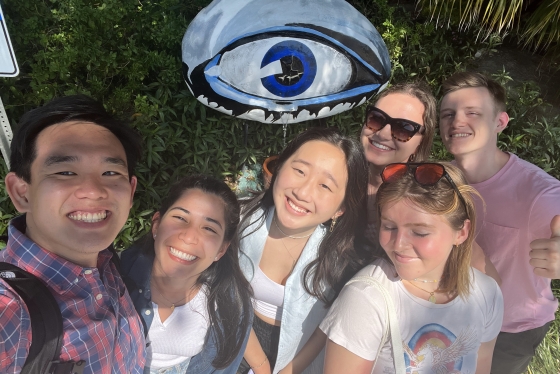 Group of students posing in front of the Dali eye