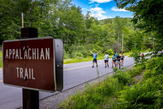 Students walking towards Appalachian Trail sign