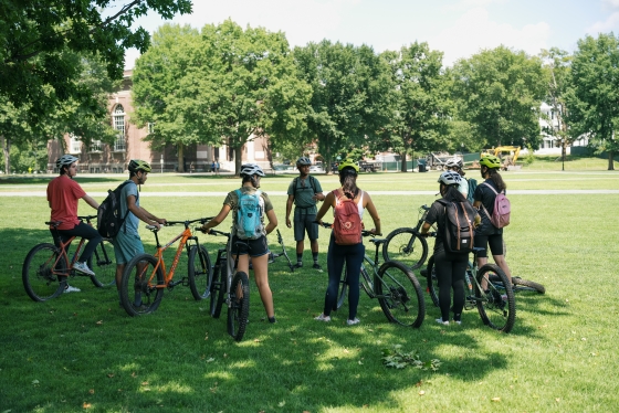 A semi circle of students with mountain bikes