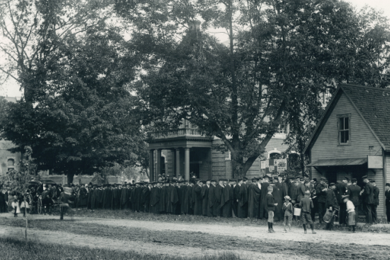 Graduates lined up outside an old Wilson Hall