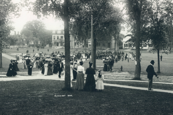 A group of people gathered on a lawn wearing dressy attire