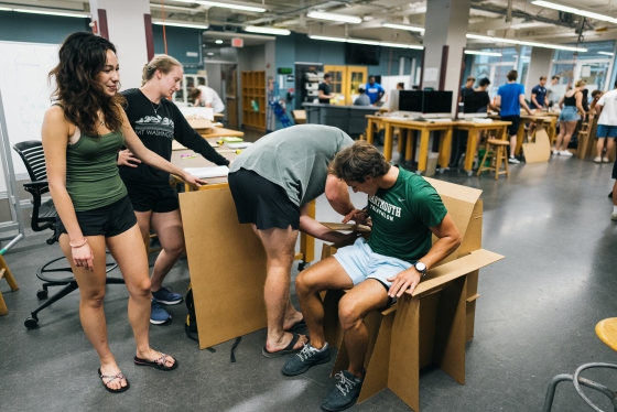 Students testing a cardboard chair