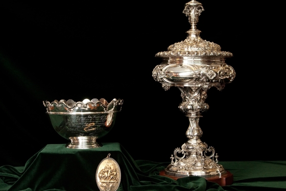 A bowl, medallion, and cup on a table.
