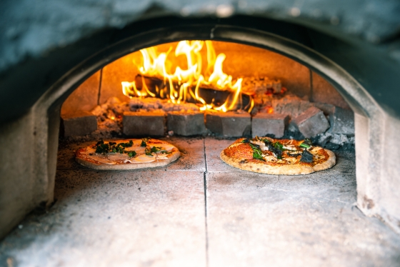 Two pizza's baking in the pizza oven