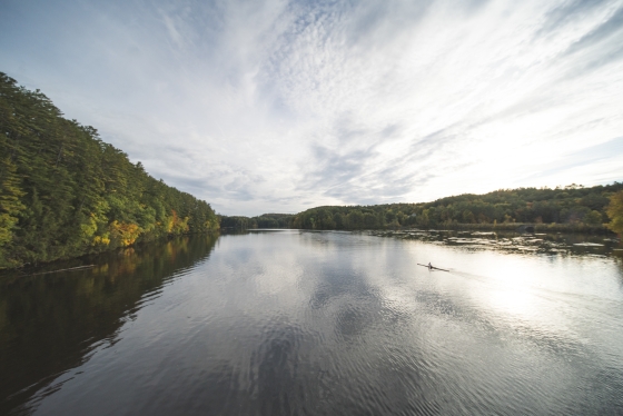 A student rowing a boat down the Connecticut River