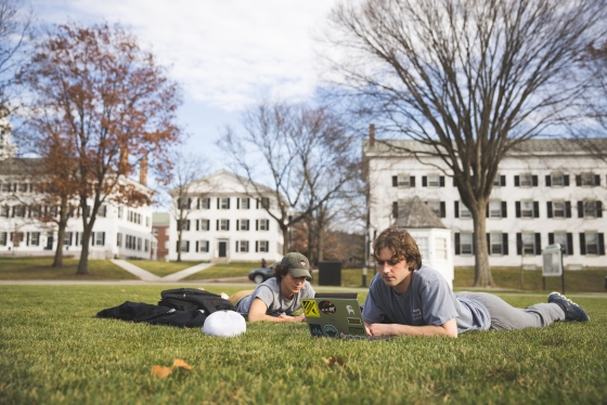 Hayden Miller '25 and Lucas Disilvestro '25 study on the Green.