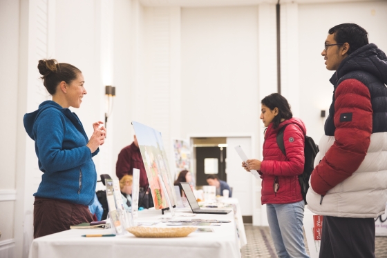 Sara Cavin, left, manager of programs for the Willing Hands food charity, talks to Vedant Tapiavala '26 during the &quot;Power Of Community&quot; kick-off event in support of Dartmouth's Granite United Way campaign on Wednesday at the Hanover Inn. 