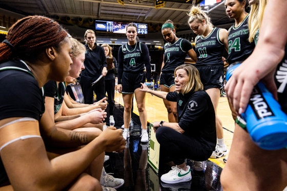 Adrienne Shibles coaching the women's basketball team