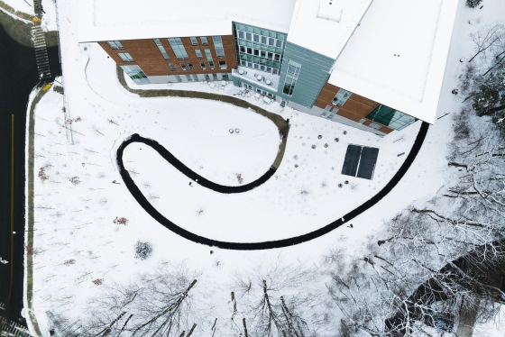 Aerial of the Center for Computer Science sidewalk contrasted by snow