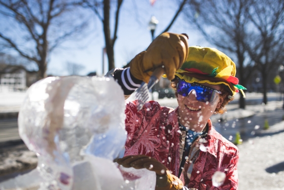 Student in yellow hat carving ice