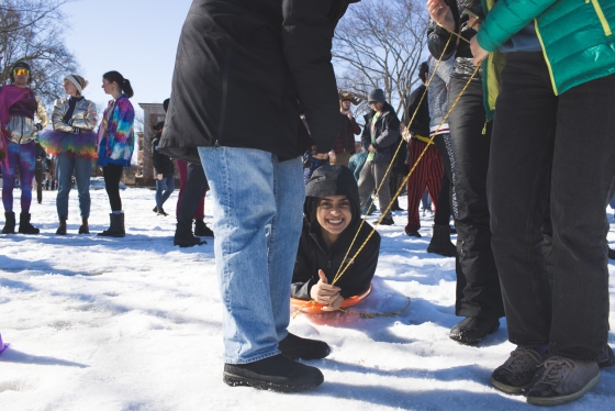 Student smiling on a sled