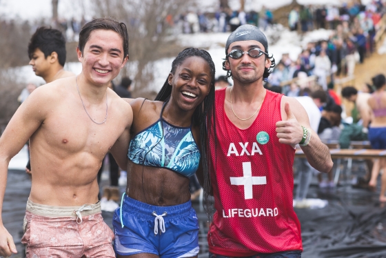 Students pose for photo after taking the polar bear swim in Occom pond