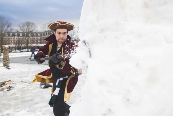 Student dressed as a pirate carving the snow sculpture