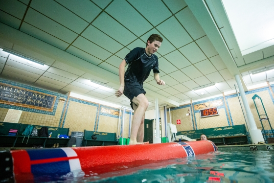 Student practices logrolling in the Spaulding Pool