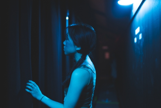 Chloe Jung waiting backstage in blue light