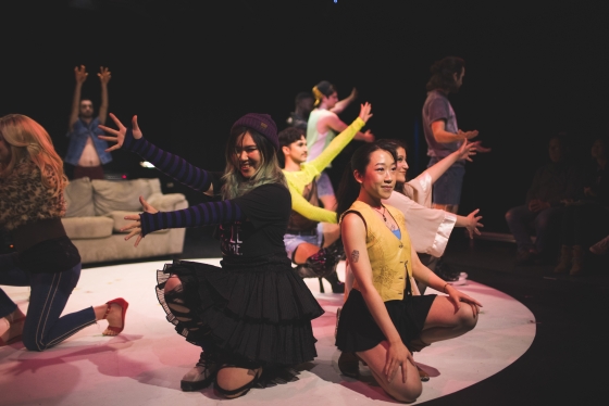 Chloe Jung performing a solo surrounded by cast members