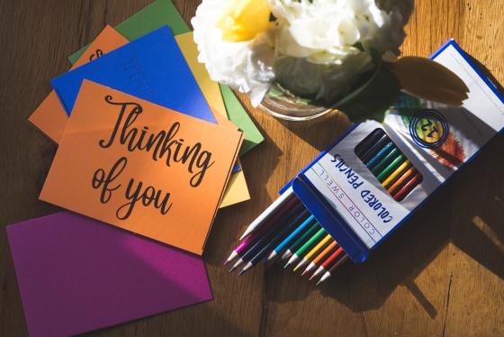 &quot;Thinking of you&quot; cards, colored pencils, and flowers.