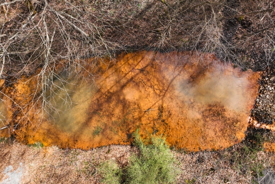 Copper colored opaque pool of liquid