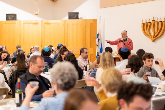 Rabbi Seth Linfield gives a blessing during the Hillel Passover Seder at the Roth Center.