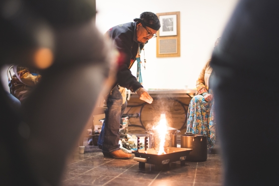 Medicine man Herbert Wilson, a citizen of the Navajo Nation, lights the ceremonial fire for a cleansing ceremony.