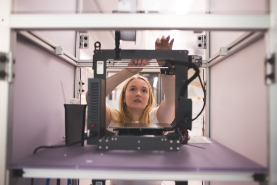 Lauren Goyette working behind a 3D printer