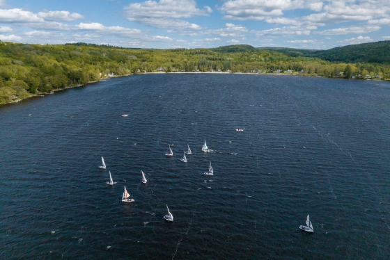Aerial view of Mascoma lake with little white sailboats dotted along the water