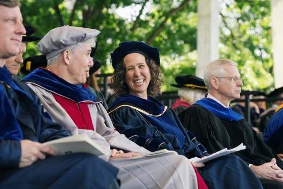 Faculty laugh during Commencement
