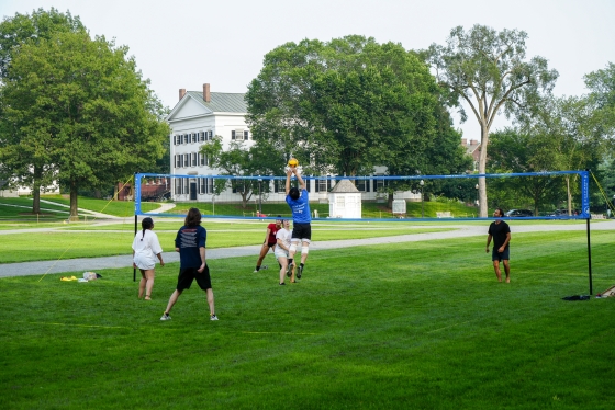 Dartmouth graduate students play a game of volleyball on the Green.