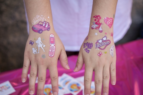 Temporary pink tattoos on Kennedy Wiehle's hands