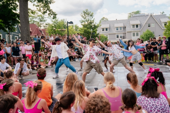 Students dancing while a crowd looks on