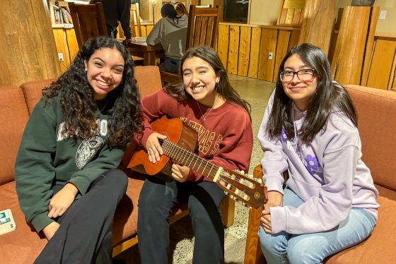 Students pose with a guitar