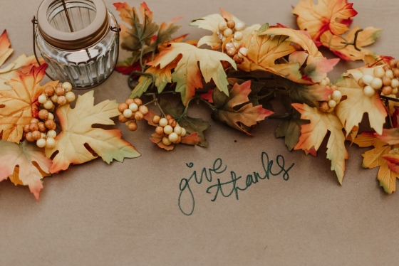 Leaf garland on table that reads &quot;Give Thanks&quot;