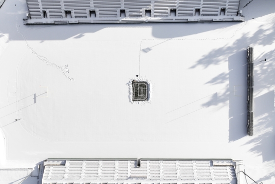 Students clear snow off the "D" on Memorial Field