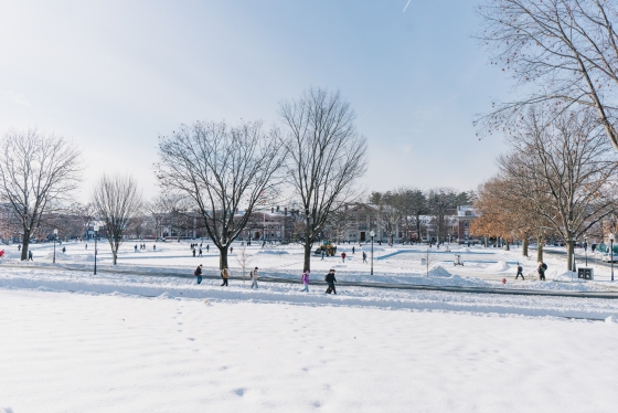 People walk across a snowy campus