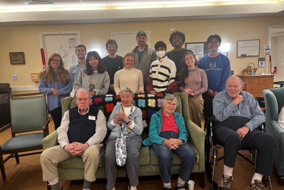 Students and residents of Kendal at Hanover pose for a photo during a visit.