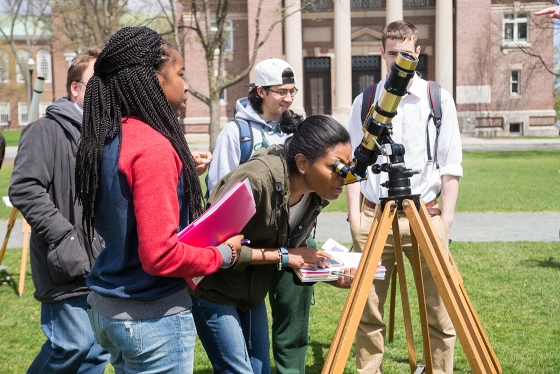 Students in Astro 001 set up telescopes on the Green