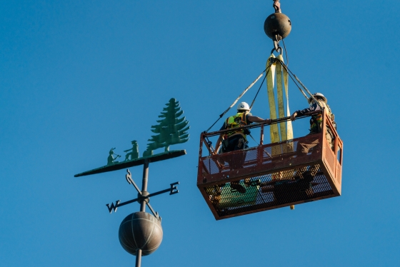 Engineers remove the weathervane from the Baker Berry Library