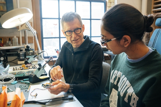 Ralph Gibson teaches Gunjan Gaur '20 about sodering circuit boards