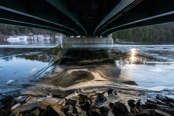 Ice and water flowing under the Ledyard Bridge
