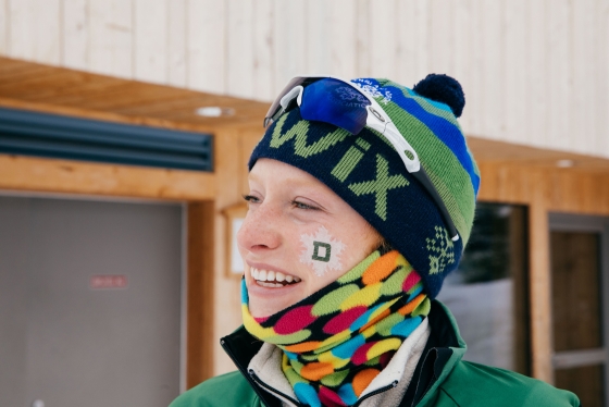 Nordic racer's ski team logo adorning her cheek